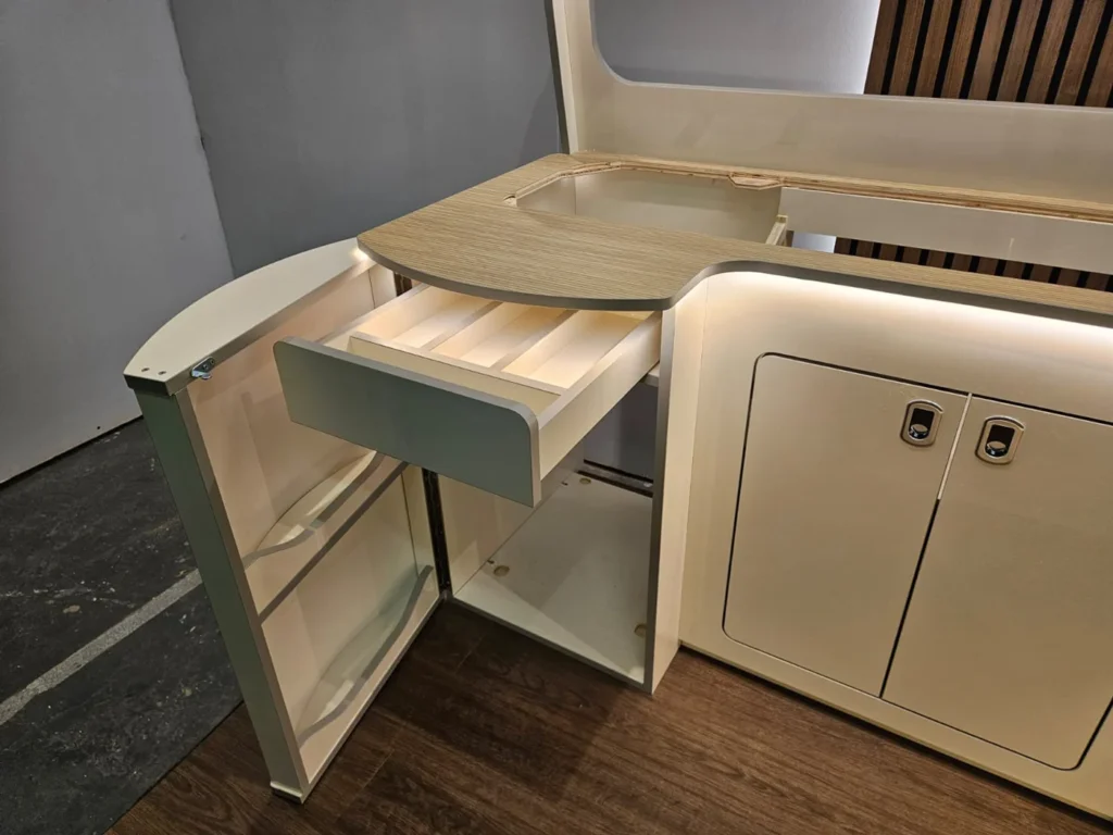 Cashmere Gloss kitchen furniture with curved fridge door and laminated sanded oak worktop